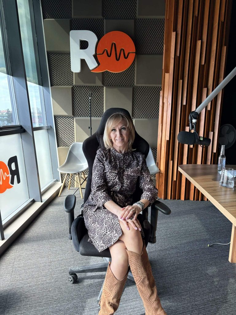 Kobieta siedząca na krześle w trakcie wywiadu w radiu